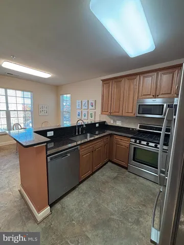 a kitchen with granite countertop a stove and cabinets