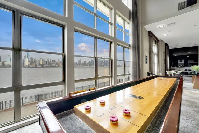 a living room with furniture ceiling fan and a window