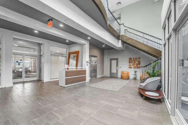 a living room with lots of furniture and a chandelier