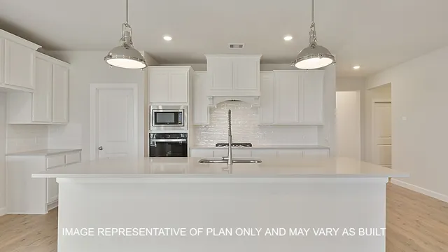 a kitchen with kitchen island a counter top space appliances and cabinets