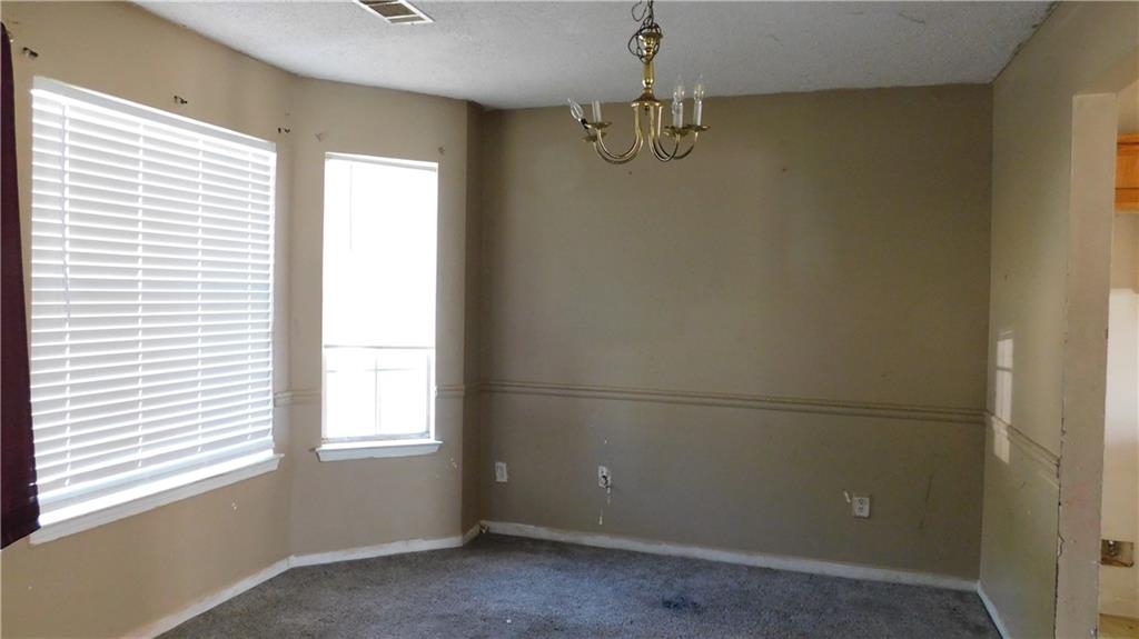 115 Windscape Drive Covington, GA 30016 - Photo 5 of 10 an empty room with a window