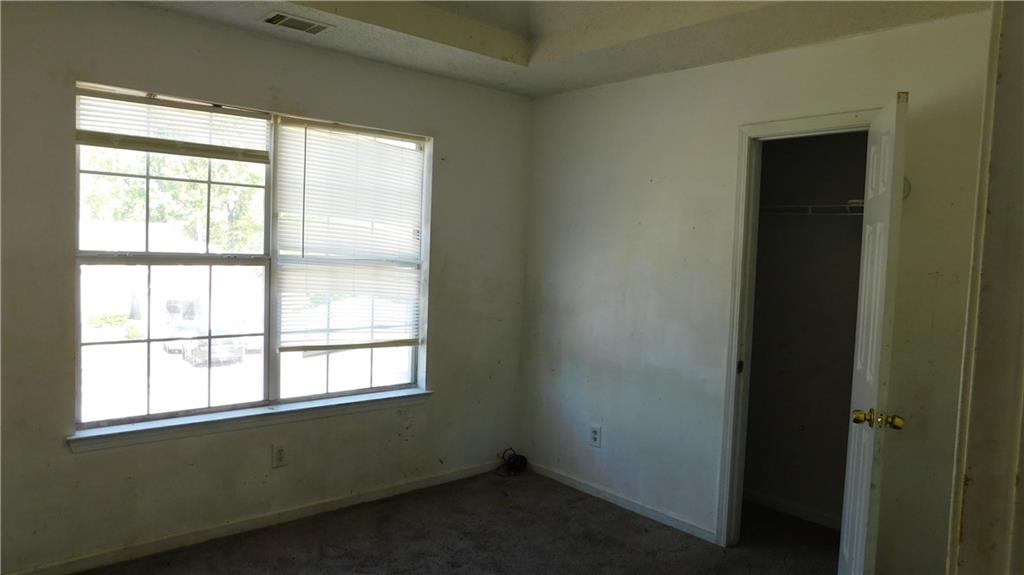 115 Windscape Drive Covington, GA 30016 - Photo 8 of 10 an empty room with a window