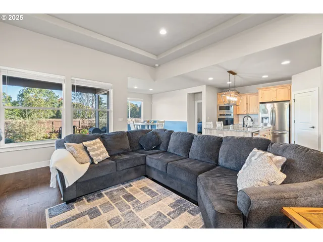 a kitchen with stainless steel appliances granite countertop a stove top oven a sink refrigerator and cabinets