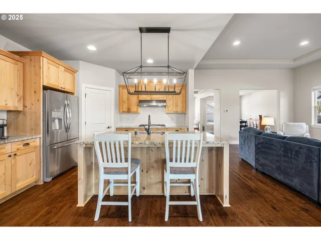 a kitchen with a granite countertop stove a sink and dishwasher