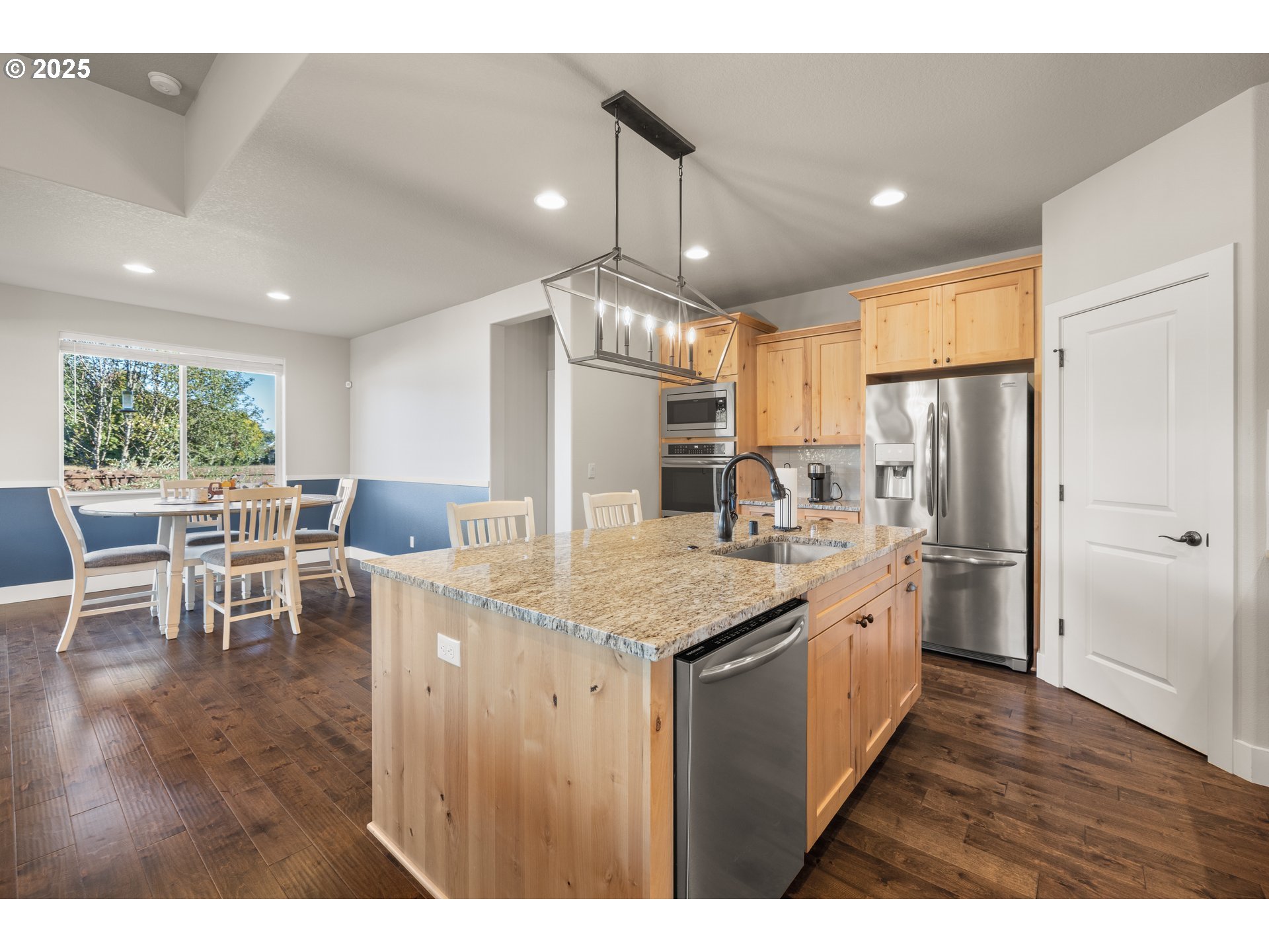 2344 Southeast 27th Street Battle Ground, WA 98604 - Photo 16 of 48 a kitchen with stainless steel appliances granite countertop a table chairs and a refrigerator