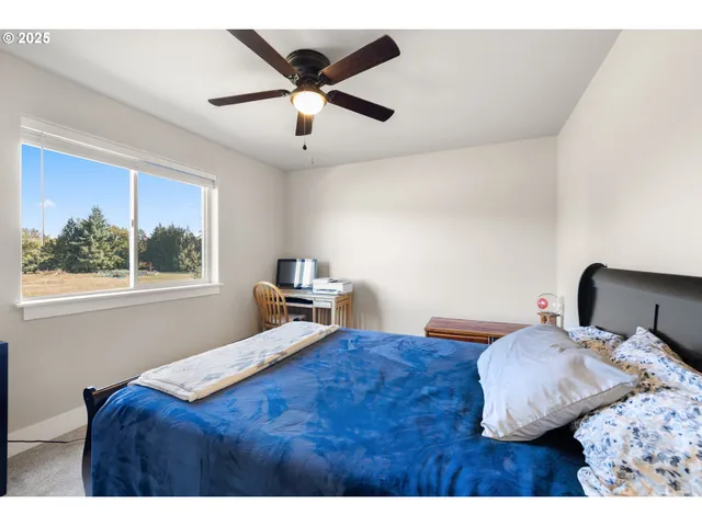 a bedroom with a bed and a painting on the wall