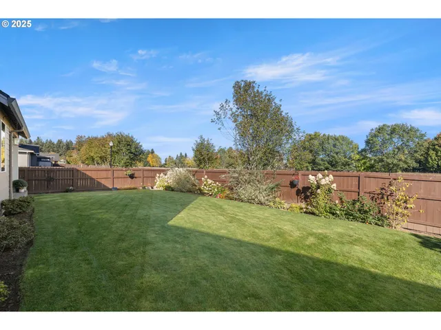 a view of a house with a yard and sitting area