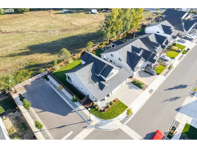 an aerial view of residential houses with outdoor space