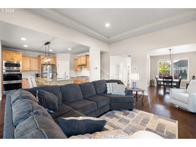 a dining room with furniture a chandelier and wooden floor