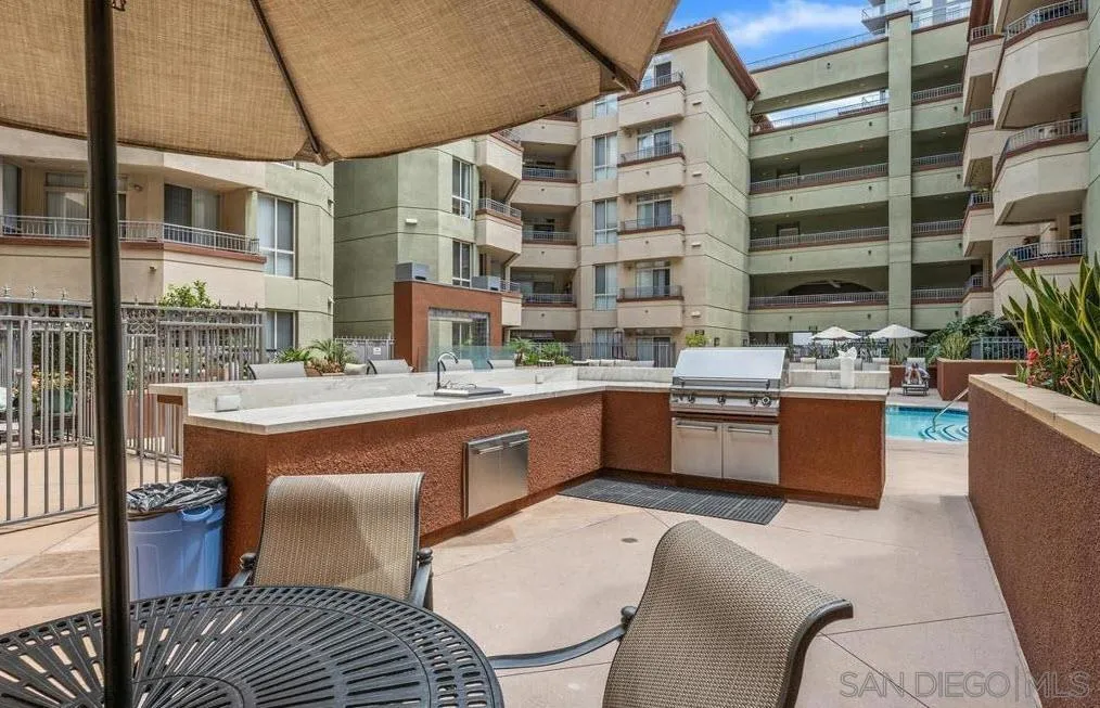 a large kitchen with stainless steel appliances kitchen island granite countertop a sink and cabinets