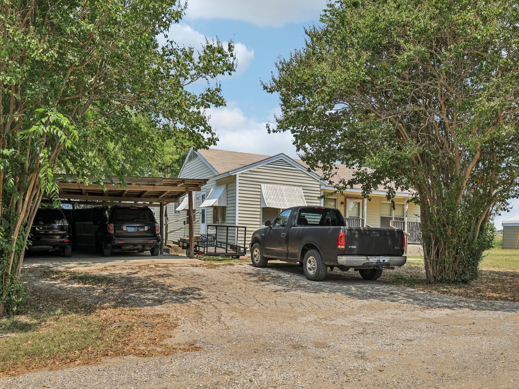 Tbd Tbd Bluebonnet Road Lockhart, TX 78644 - Photo 9 of 20 a car parked in front of white house