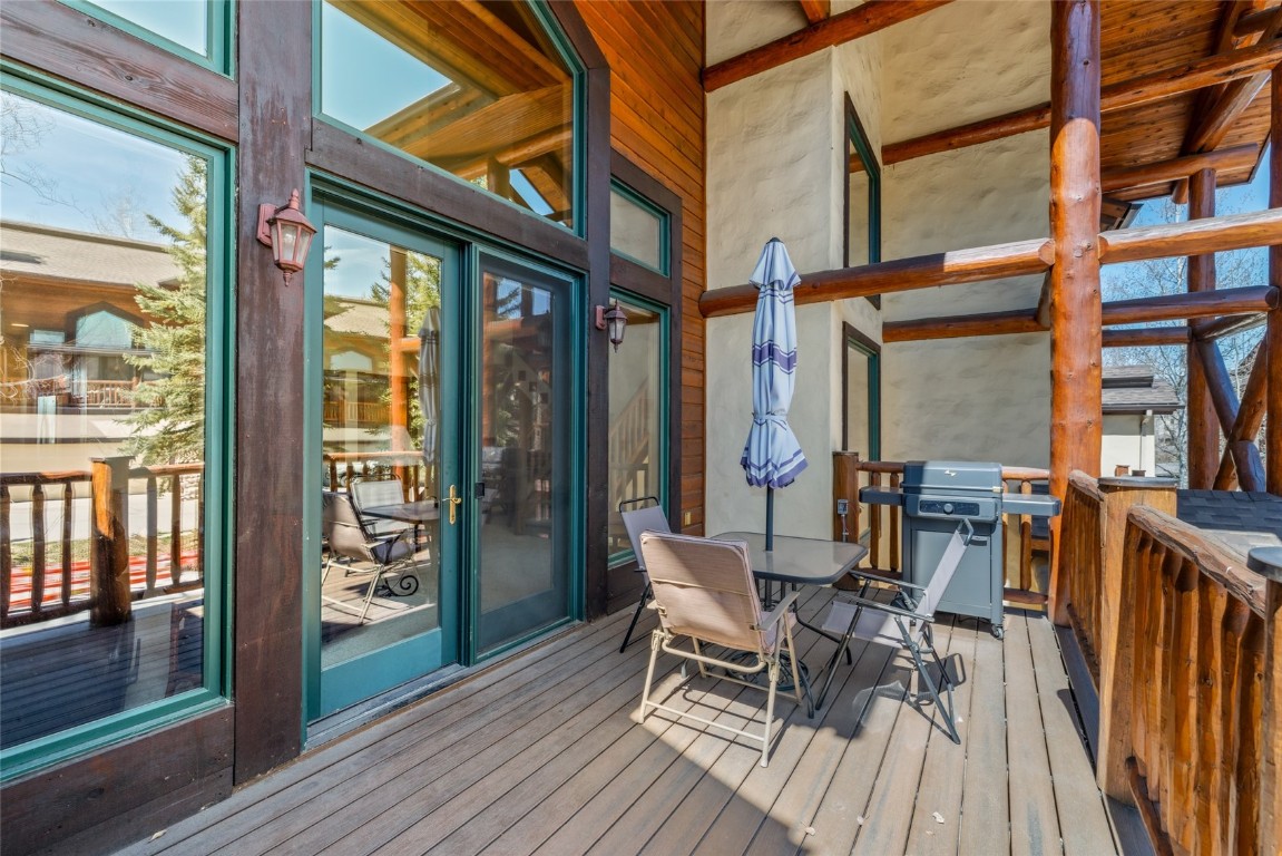 2685 Timber Court, Unit 2 Steamboat Springs, CO 80487 - Photo 11 of 31 Wooden terrace featuring a grill and outdoor dining area