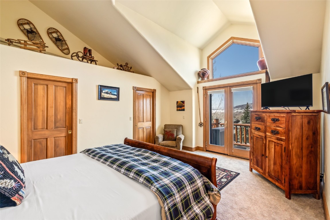 2685 Timber Court, Unit 2 Steamboat Springs, CO 80487 - Photo 13 of 31 Bedroom with light carpet, access to exterior, and vaulted ceiling