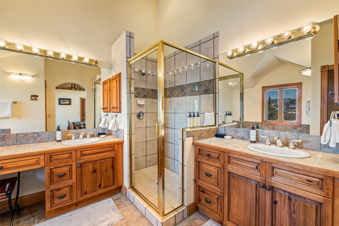 2685 Timber Court, Unit 2 Steamboat Springs, CO 80487 - Photo 17 of 31 Full bath with a shower stall, two vanities, and a sink