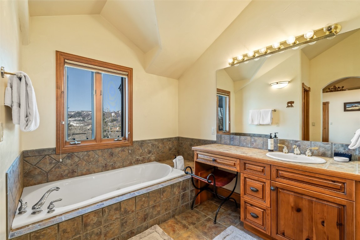 2685 Timber Court, Unit 2 Steamboat Springs, CO 80487 - Photo 18 of 31 Bathroom with a garden tub, vanity, and vaulted ceiling