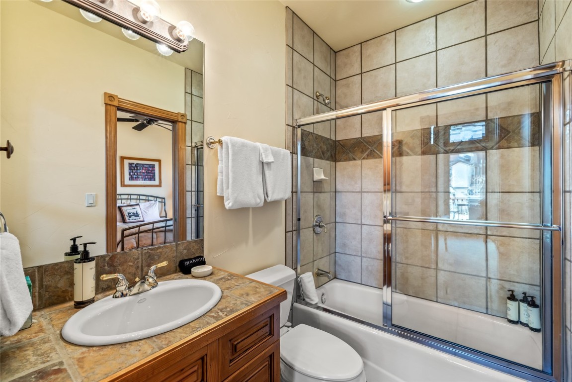 2685 Timber Court, Unit 2 Steamboat Springs, CO 80487 - Photo 20 of 31 Full bathroom featuring shower / bath combination with glass door, vanity, and toilet