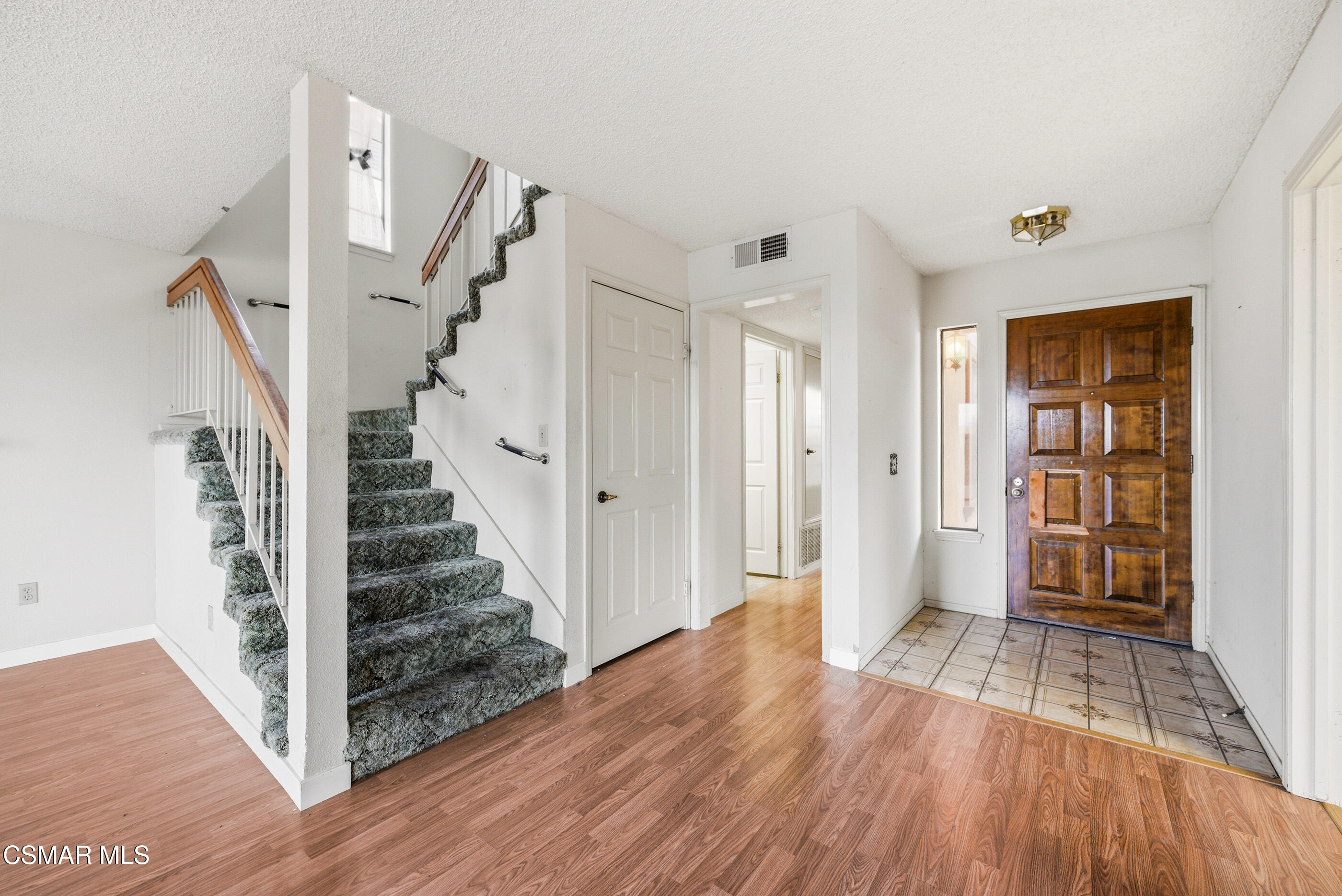 12036 Shadow Ridge Way Porter Ranch, CA 91326 - Photo 22 of 35 a view of a hallway with wooden floor and entryway
