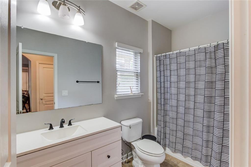 7772 Copper Kettle Way Flowery Branch, GA 30542 - Photo 16 of 43 a bathroom with a sink toilet vanity and mirror
