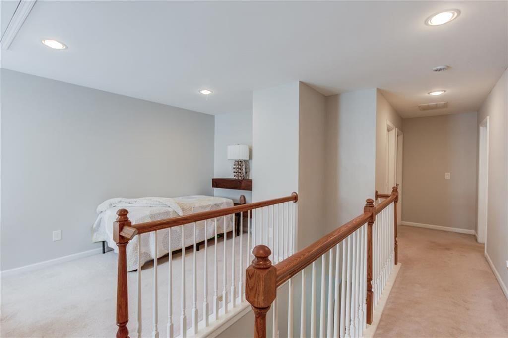 7772 Copper Kettle Way Flowery Branch, GA 30542 - Photo 19 of 43 a view of a hallway with stairs