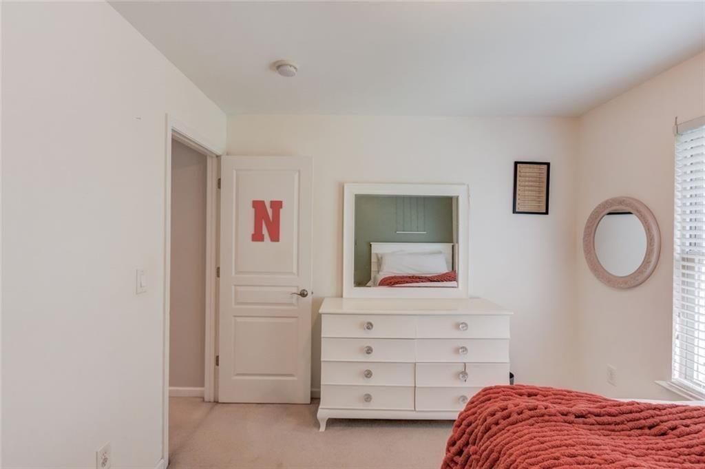 7772 Copper Kettle Way Flowery Branch, GA 30542 - Photo 30 of 43 a bedroom with a bed and a cabinets