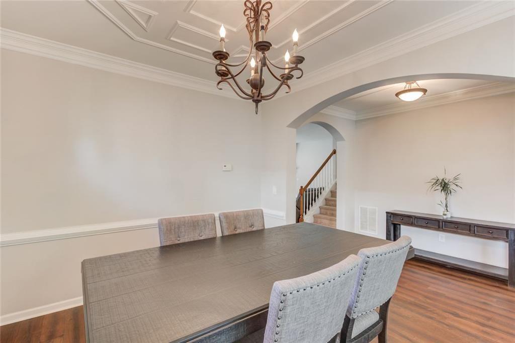 7772 Copper Kettle Way Flowery Branch, GA 30542 - Photo 6 of 43 a view of livingroom and dining room with wooden floor