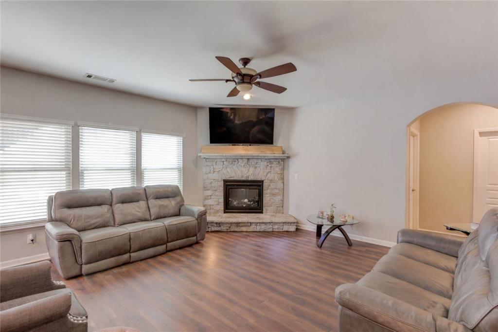 7772 Copper Kettle Way Flowery Branch, GA 30542 - Photo 7 of 43 a living room with furniture and a fireplace