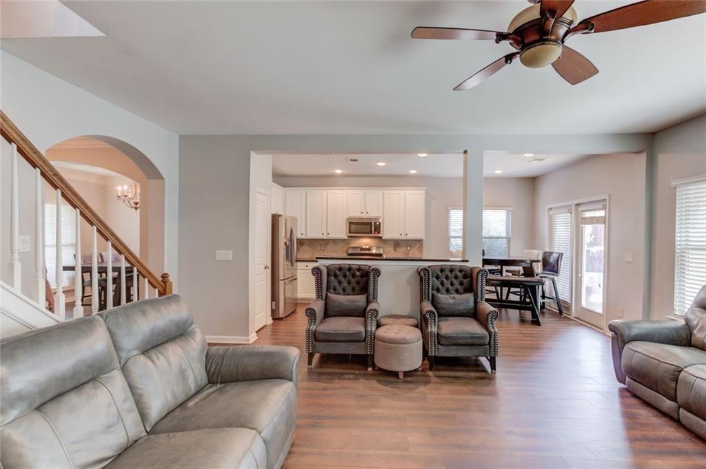 7772 Copper Kettle Way Flowery Branch, GA 30542 - Photo 8 of 43 a living room with furniture kitchen view and a dining table