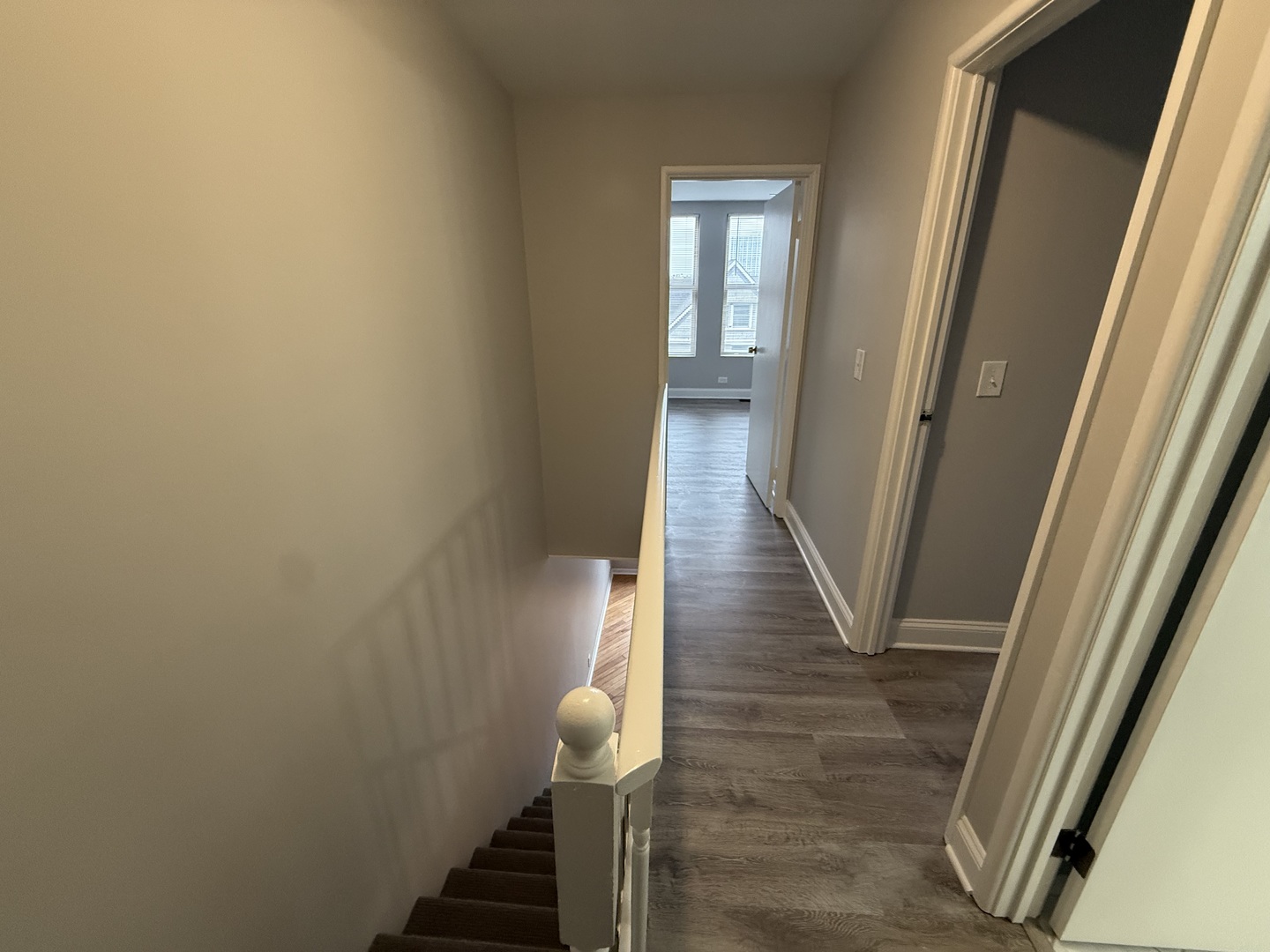 744 West Gordon Terrace, Unit 305 Chicago, IL 60613 - Photo 7 of 12 a view of a hallway with wooden floor and staircase