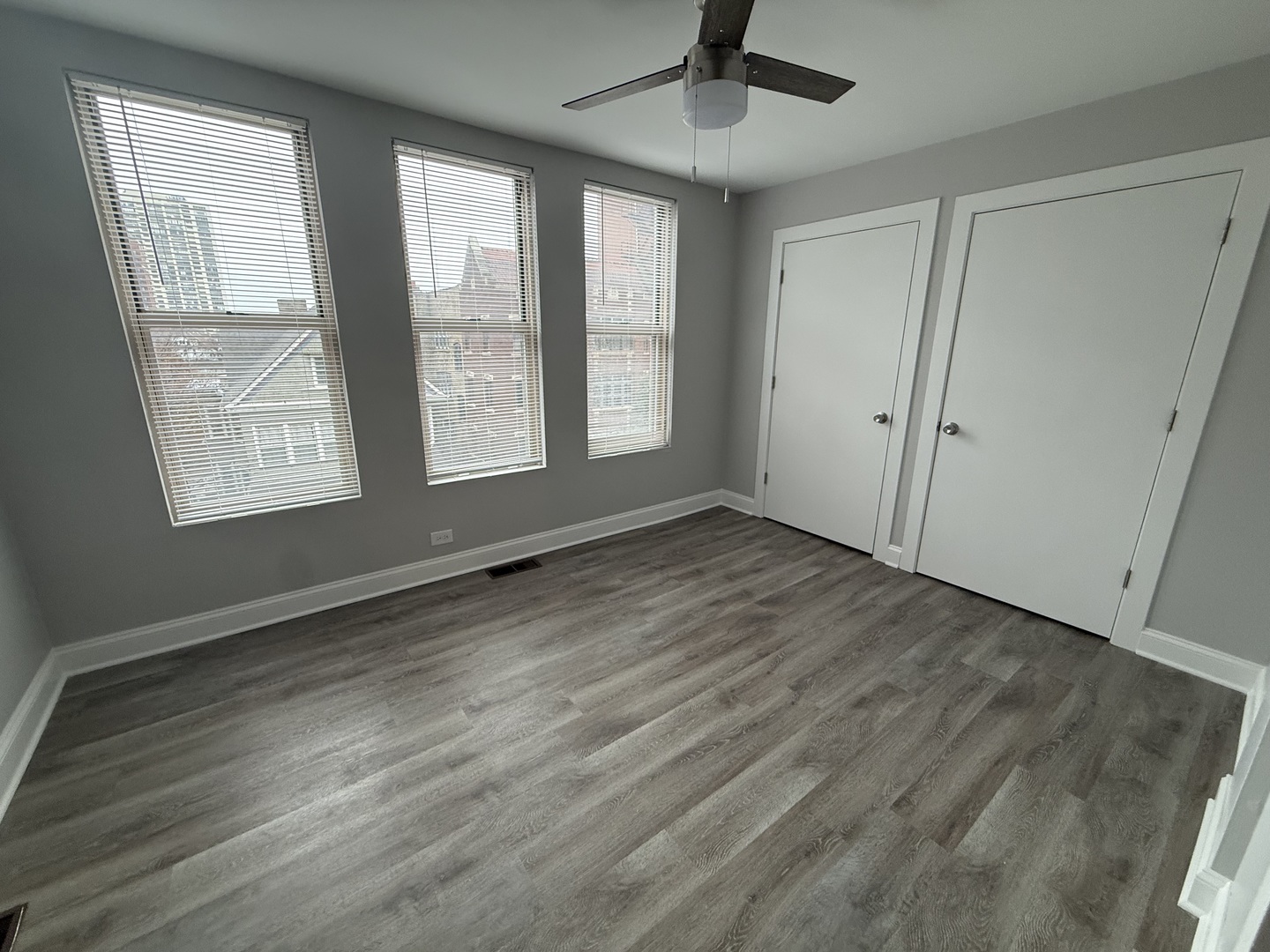 744 West Gordon Terrace, Unit 305 Chicago, IL 60613 - Photo 8 of 12 a view of an empty room with wooden floor and a window
