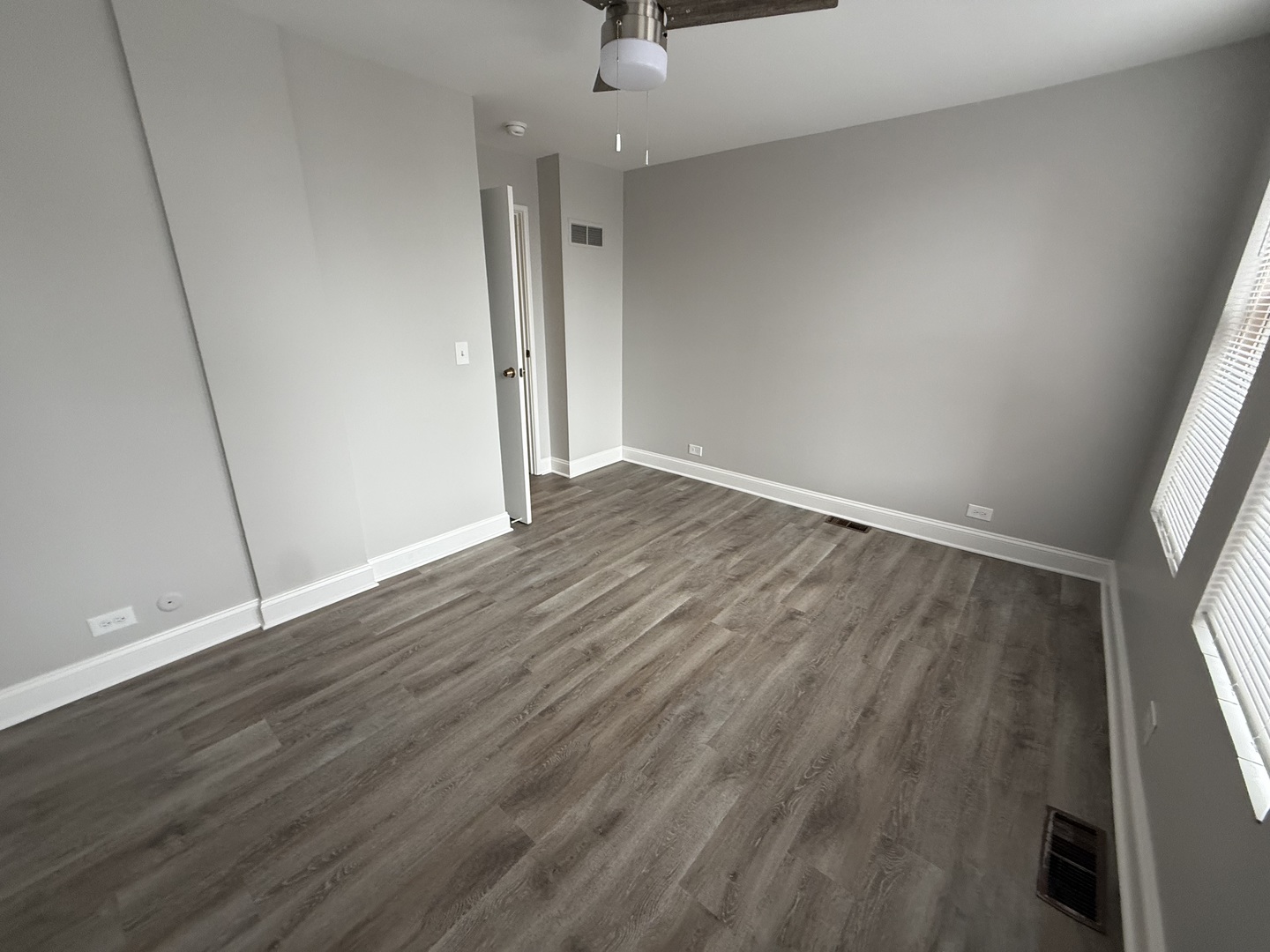 744 West Gordon Terrace, Unit 305 Chicago, IL 60613 - Photo 9 of 12 wooden floor in an empty room with a window
