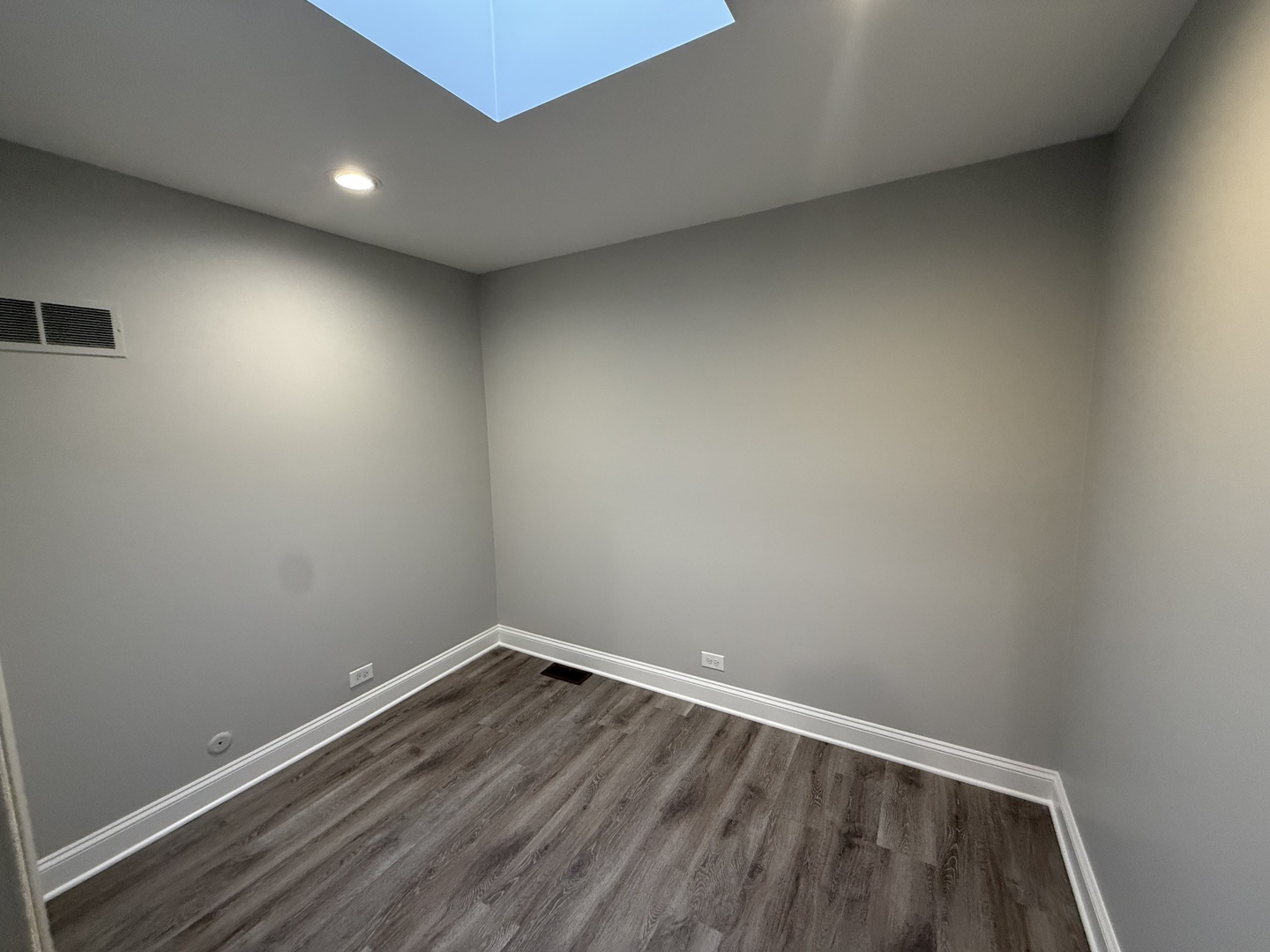 744 West Gordon Terrace, Unit 305 Chicago, IL 60613 - Photo 10 of 12 an empty room with wooden floor and windows