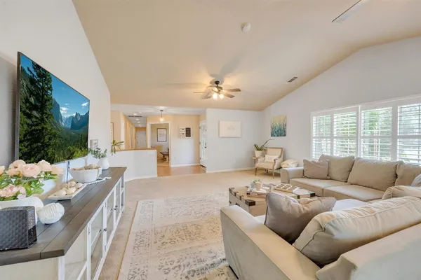 a kitchen with a stove a sink a microwave a refrigerator and cabinets