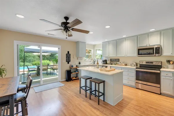 a kitchen with a sink cabinets and stainless steel appliances