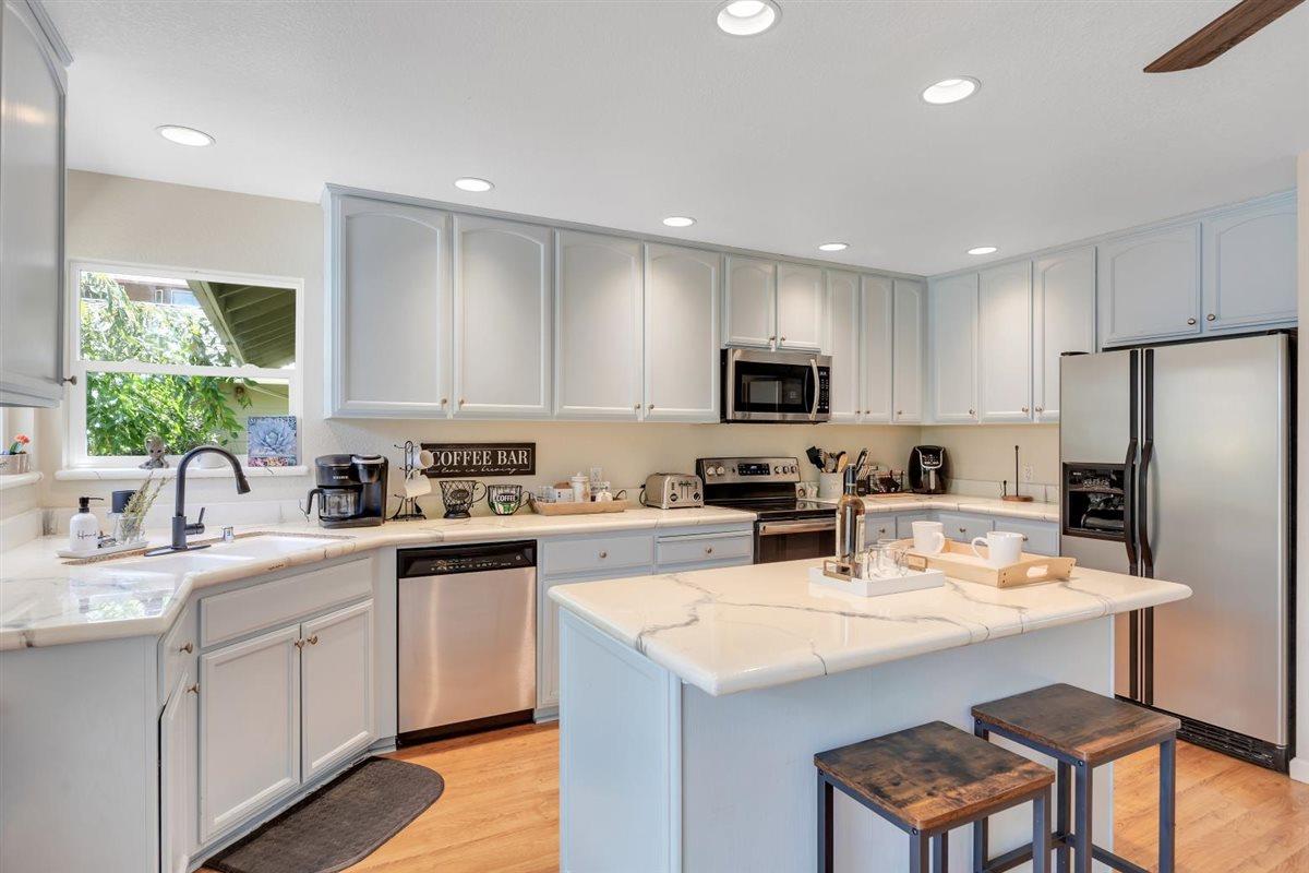 2441 Quail Hill Road, Unit 262 Copperopolis, CA 95228 - Photo 20 of 90 a kitchen with a sink a stove a refrigerator a center island and chairs