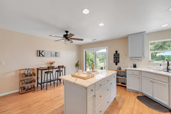a view of a bathroom with a window and a ceiling fan