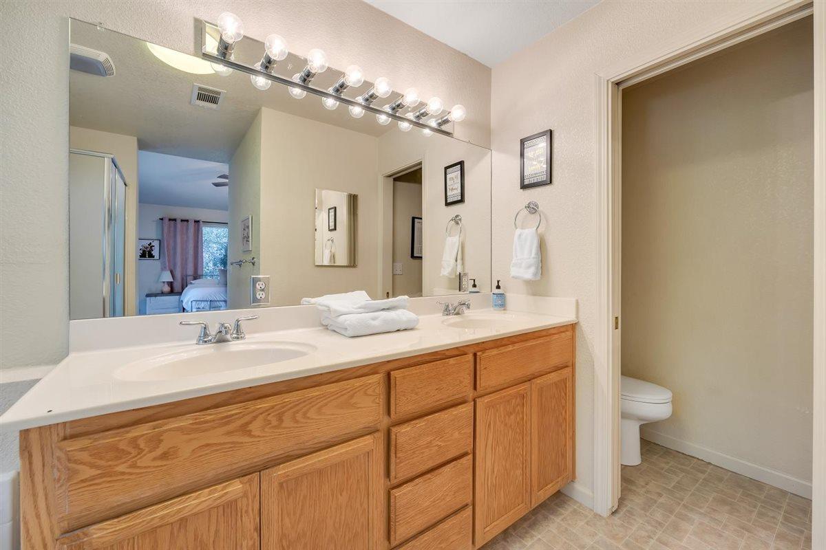 2441 Quail Hill Road, Unit 262 Copperopolis, CA 95228 - Photo 33 of 90 a bathroom with a double vanity sink mirror and toilet