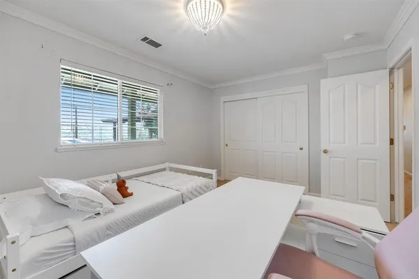 a aerial view of a house with a yard and a large tree