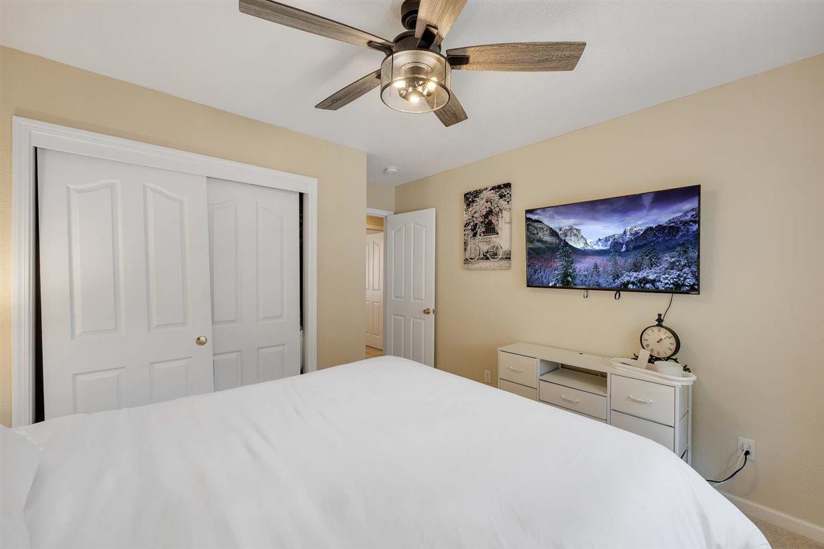 2441 Quail Hill Road, Unit 262 Copperopolis, CA 95228 - Photo 41 of 90 a bedroom with a bed and a chandelier