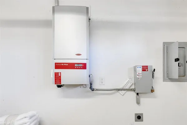 an aerial view of residential houses with outdoor space and trees