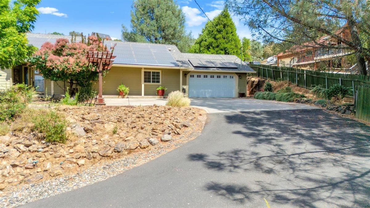 2441 Quail Hill Road, Unit 262 Copperopolis, CA 95228 - Photo 5 of 90 a front view of a house with a yard and garage