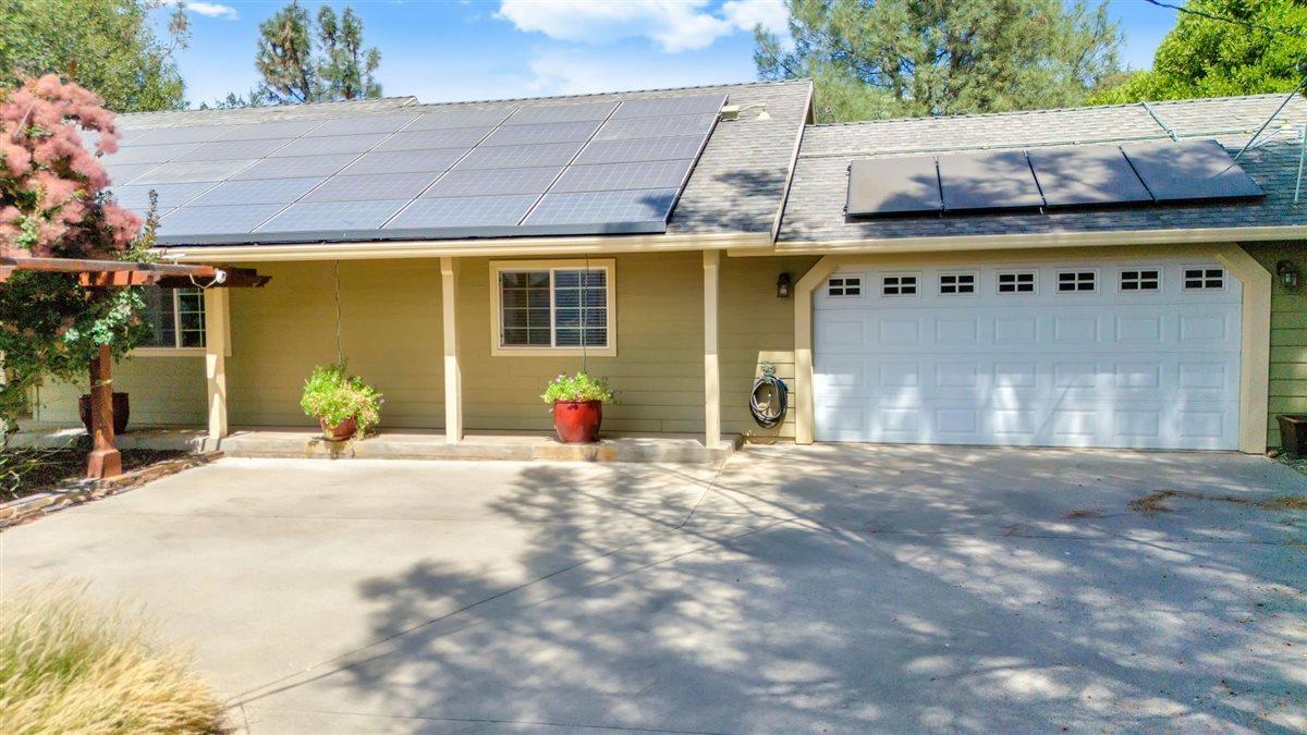 2441 Quail Hill Road, Unit 262 Copperopolis, CA 95228 - Photo 7 of 90 a front view of a house with a yard and garage