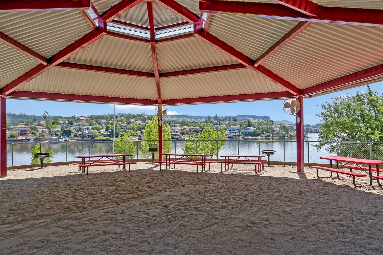2441 Quail Hill Road, Unit 262 Copperopolis, CA 95228 - Photo 74 of 90 a view of a roof deck with a table and chairs under an umbrella