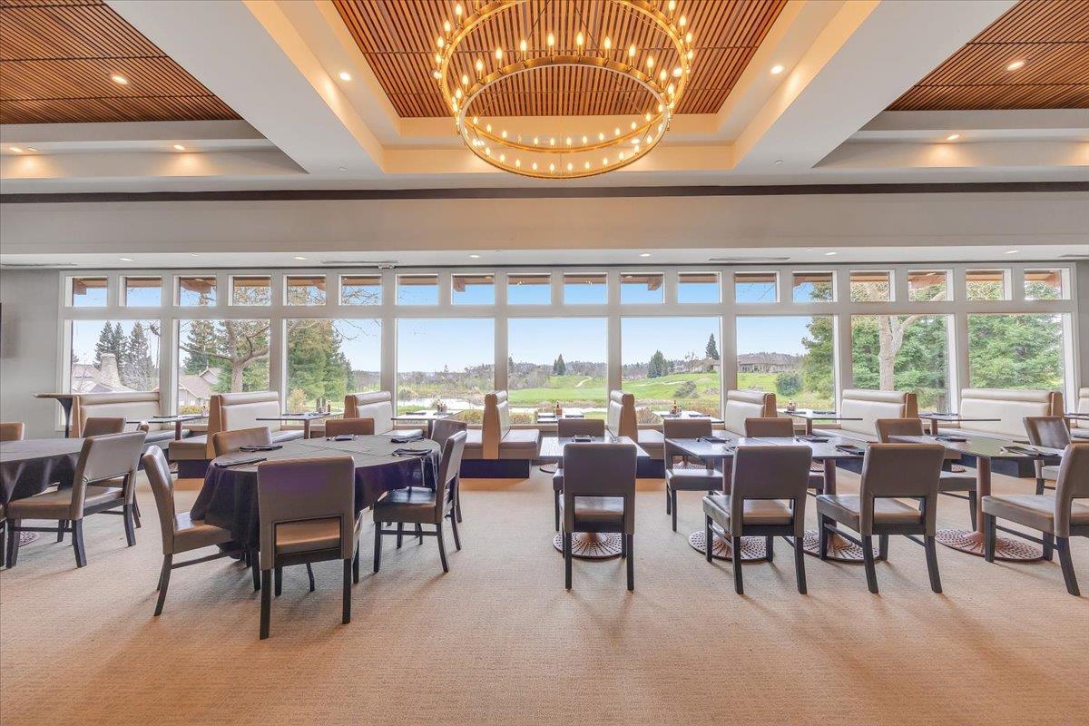 2441 Quail Hill Road, Unit 262 Copperopolis, CA 95228 - Photo 83 of 90 a room with lots of tables a large window and chairs