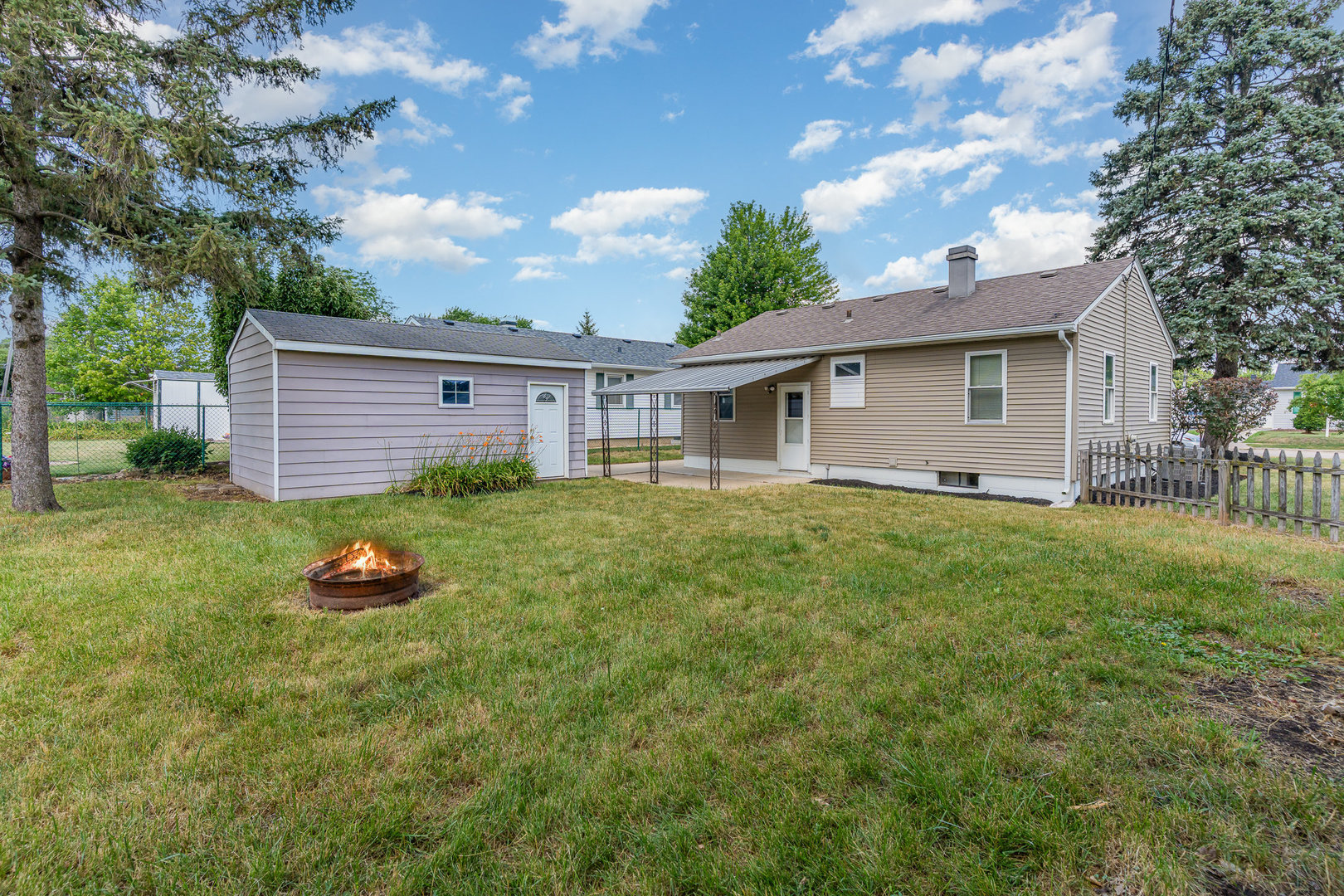 119 Riverside Drive Montgomery, IL 60538 - Photo 14 of 18 a backyard of a house with plants and barbeque oven