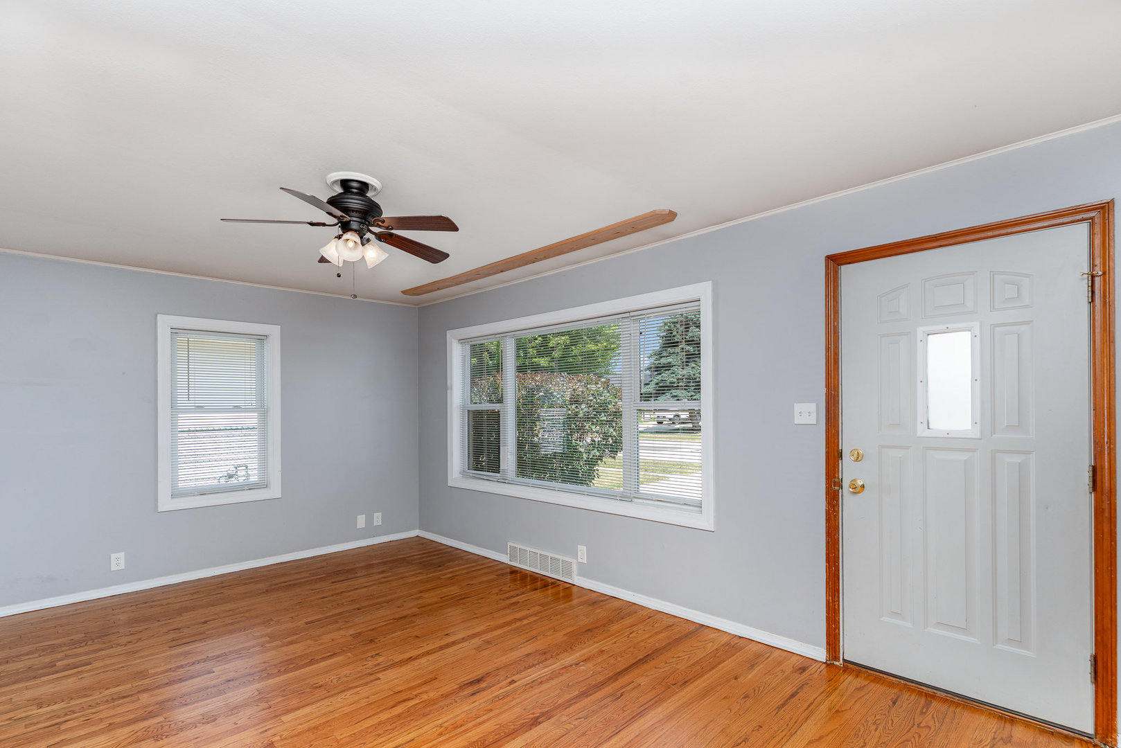 119 Riverside Drive Montgomery, IL 60538 - Photo 2 of 18 a view of empty room with wooden floor and fan