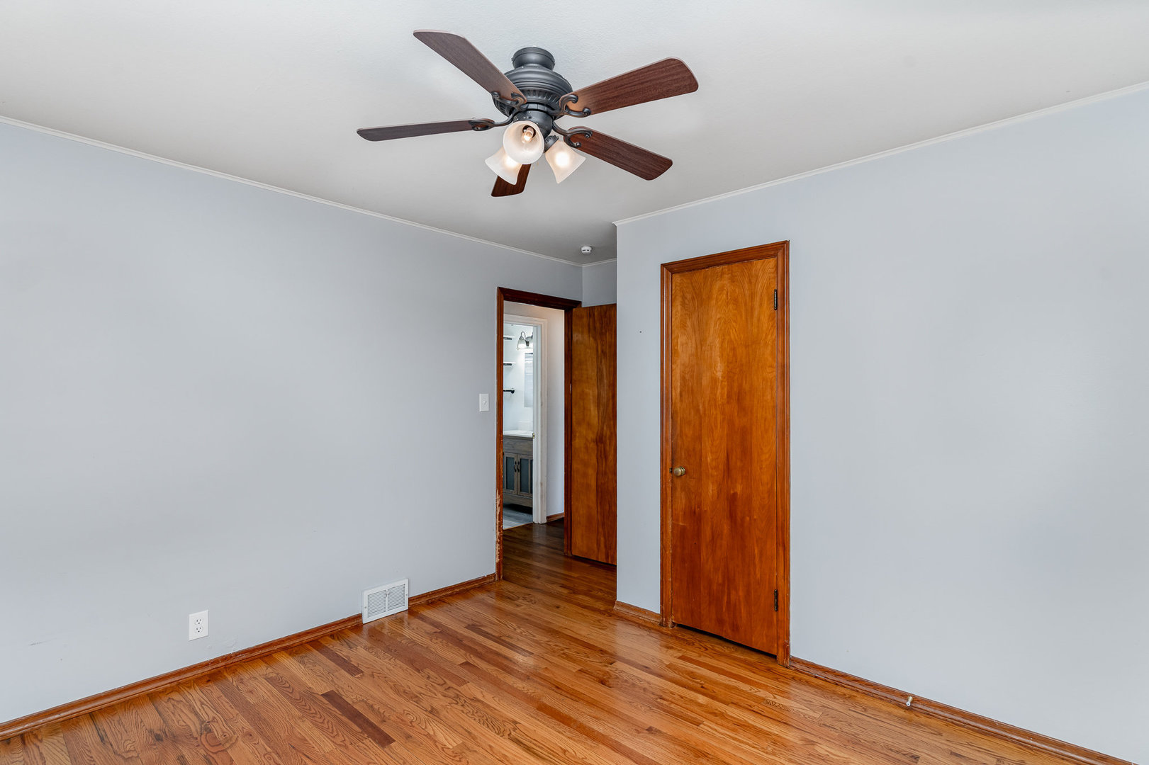 119 Riverside Drive Montgomery, IL 60538 - Photo 9 of 18 an empty room with wooden floor ceiling fan and windows