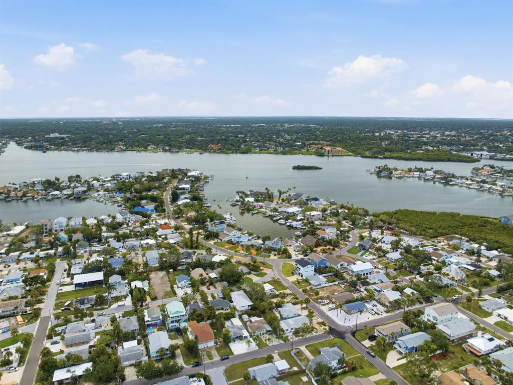 1207 1st Street Indian Rocks Beach, FL 33785 - Photo 47 of 60 an aerial view of a city with lots of residential buildings and ocean view in back
