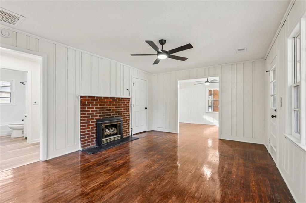 3014 Bronco Lane Gainesville, GA 30507 - Photo 11 of 37 a view of an empty room with wooden floor and a fireplace