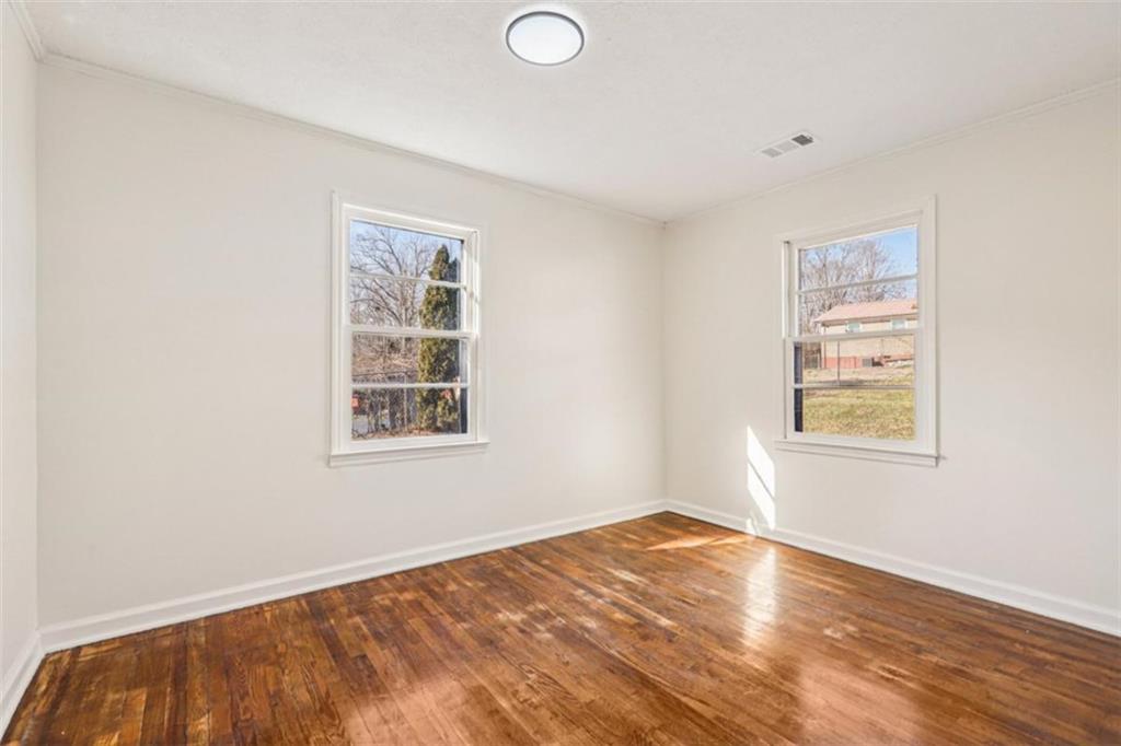 3014 Bronco Lane Gainesville, GA 30507 - Photo 19 of 37 a view of a bedroom with wooden floor and window