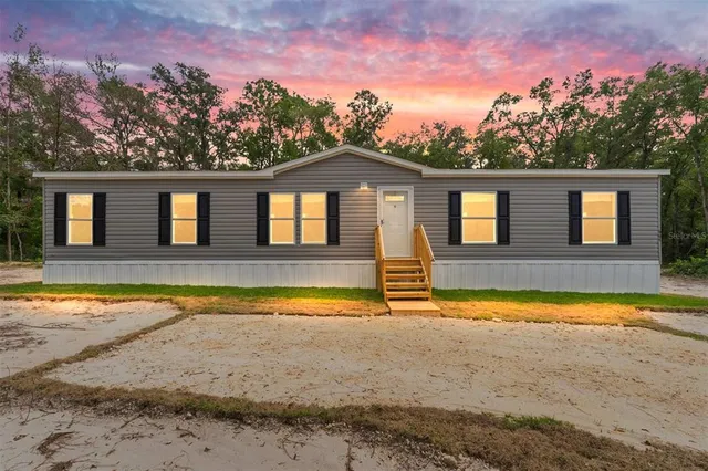 a view of a house with a swimming pool and a yard